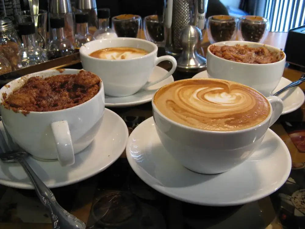 Cups of coffee on a busy café table